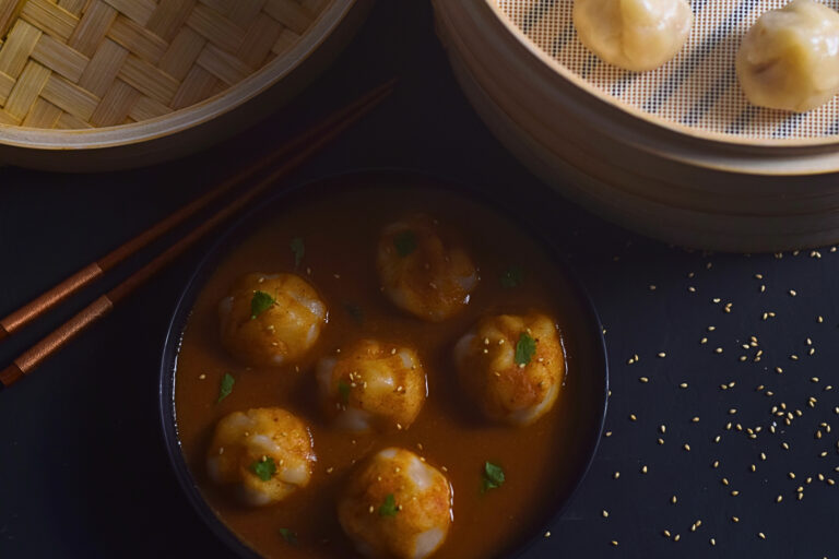 dark and moody photo of momos in a bowl