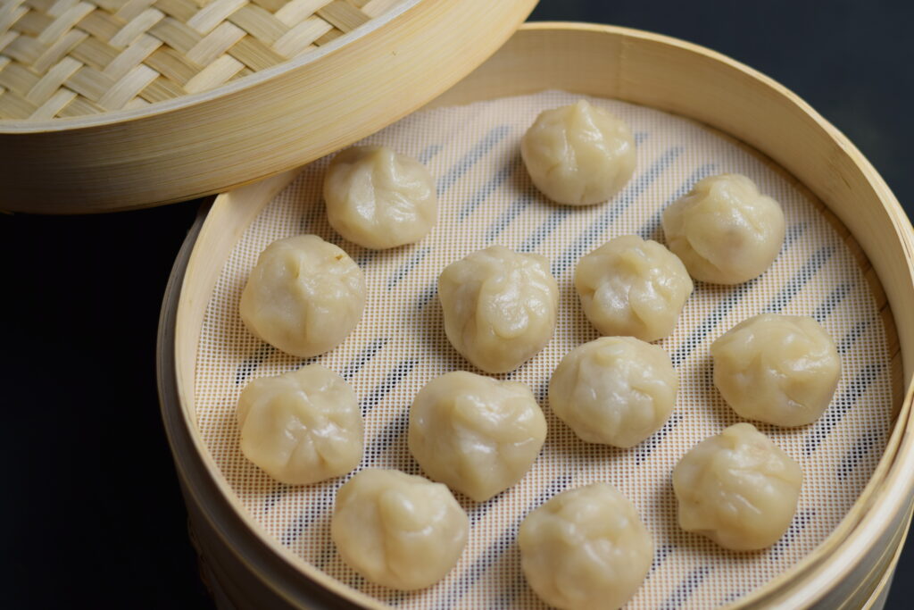 momos in a bamboo steamer basket